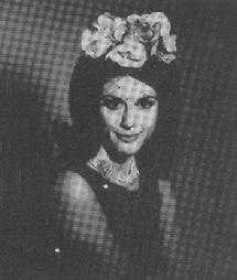 Bouffant hairstyle of the 1960s topped with a charming floral headpiece with veil (photo from the defunct American magazine "Hats" December 1965 issue)